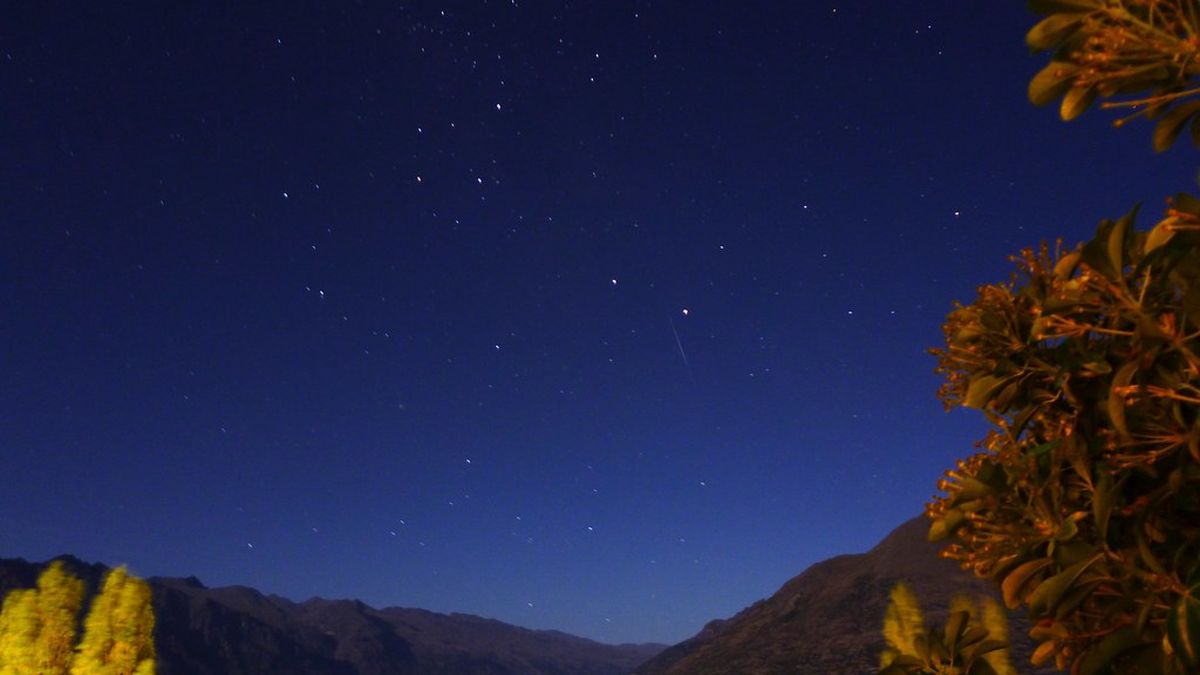 A starry night sky over mountains