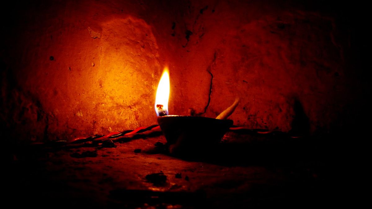 A small oil lamp burning in the dark